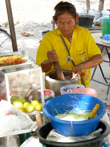 woman making our green papaya salad